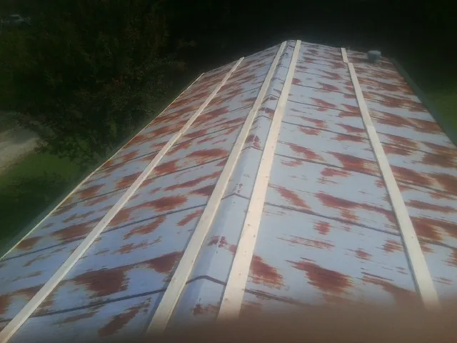 Rusted metal roof panels with new wood purlins before replacement — Storm Damage Roof Repair in Wood River by Roofing Brothers