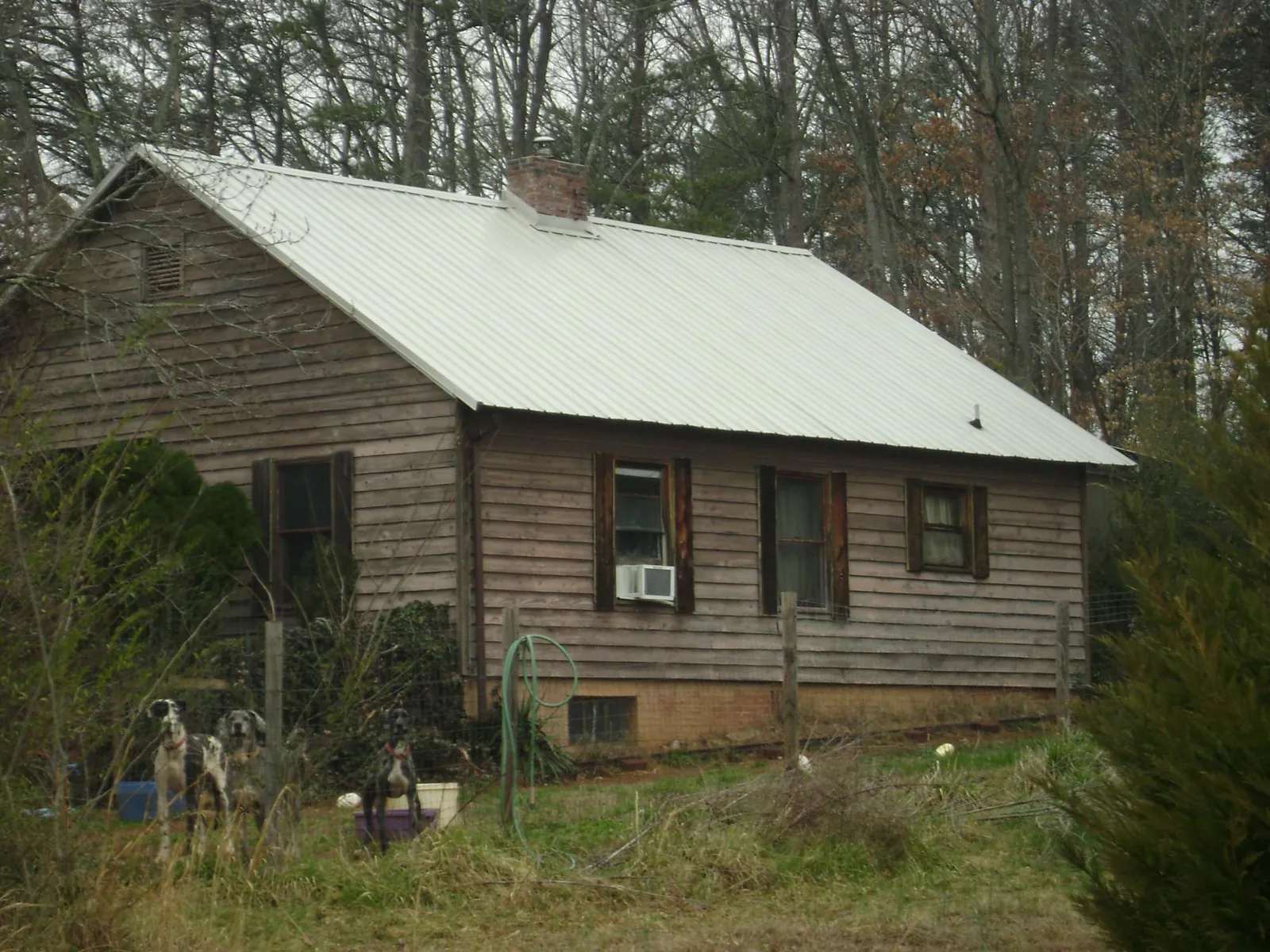 White metal roof on an old wood sided farmhouse, from a Metal Roof Installation job in Wood River